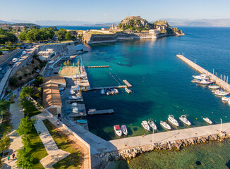 Aerial drone view of beautiful corfu town with Old Fortress in background in greece  - obrazy, fototapety, plakaty