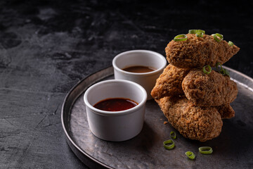 Asian fusion vegan meat-free jackfruit drumsticks with sweet hot sesame sauce and vegan BBQ