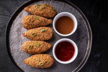 Asian fusion vegan meat-free jackfruit drumsticks with sweet hot sesame sauce and vegan BBQ