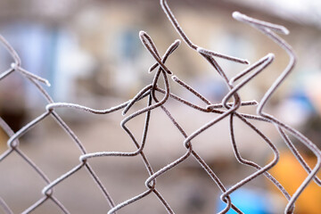 Winter. Wire mesh covered with hoarfrost close-up.