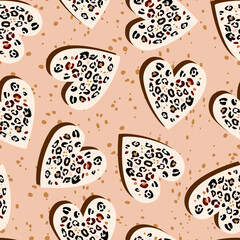 Seamless pattern from a stylized leopard pattern inside a heart. Pink background concept Love, beauty, fashion. drawing of silhouette icon of heart and patches of animal skin.