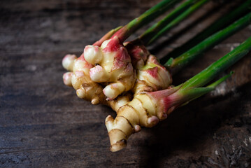 A fresh tender ginger on a wooden table