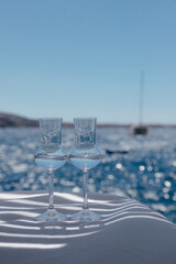 Closeup view of two fantastic beautiful glasses with transparent national alcohol drink on white...