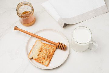 Croutons for breakfast with honey and milk.