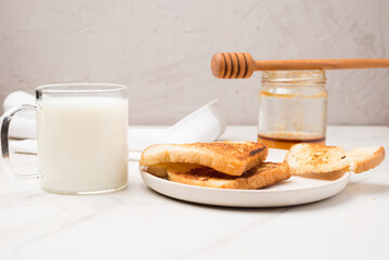 Croutons for breakfast with honey and milk.