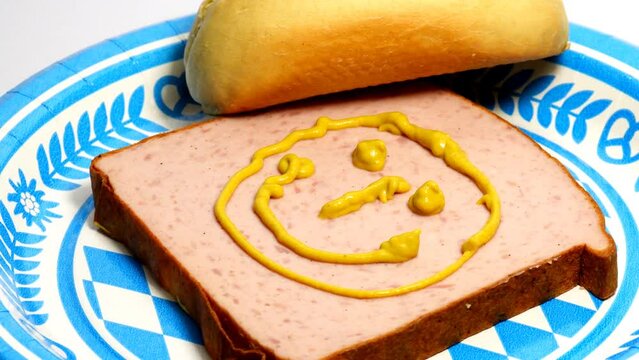 Bavarian meatloaf with mustard on a turn table
