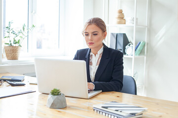 Fototapeta premium Beautiful young businesswoman working on computer