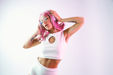 Young woman with pink hair dancing and having fun