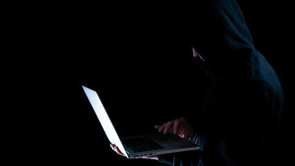Cyber security hacker concept. Internet web hack technology. Digital laptop in hacker man hand isolated on black banner. Data protection, secured internet access, cybersecurity.