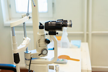 Checking the eye vision with modern optical equipment. Ophthalmology medical equipment. 
