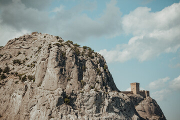 Genoese fortress on a rock against a summer blue sky