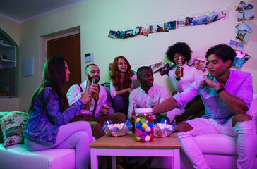 A group of young people celebrating and making party at home