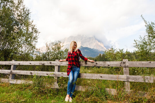 Young beautiful woman traveler , mountains Alps background,