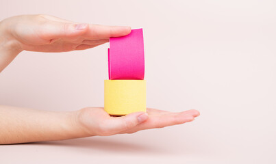 Woman hands holding kinesio tapes rolls. Kinesiology, physical therapy, rehabilitation concept