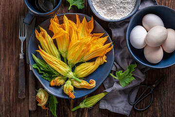 Preparation for fried zucchini flower as a seasonal summer snack.