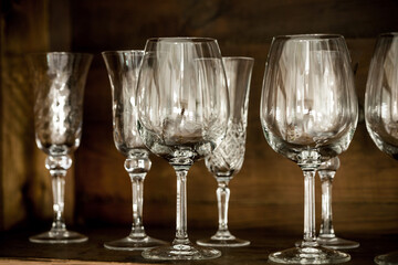 glasses on the shelf of an old cabinet