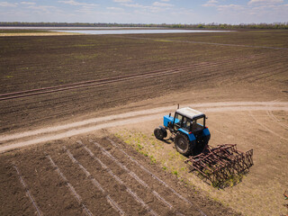 Obraz premium Tractor parked near the field. Aerial drone photo.