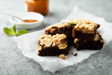 Traditional homemade brownies with caramel and peanut