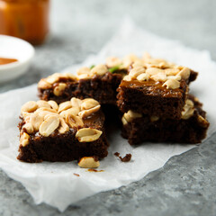 Traditional homemade brownies with caramel and peanut