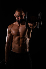 Fototapeta na wymiar Portrait of guy lifting weights