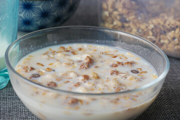 breakfast cereal and milk on a bowl on table 
