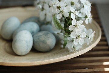 Fototapeta na wymiar FILE #: 414878337 Preview Crop Find Similar Plate with nordic Easter eggs on white background. Flat lay, top view. Happy Easter concept.