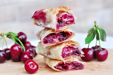 Delicious Homemade Cherry Pie.Sweet slices of cherry strudel on a wooden table. Traditional...