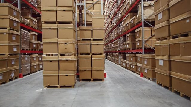 A warehouse with many boxes on its shelves waiting for export.  Logistic center is ready for distribution.

