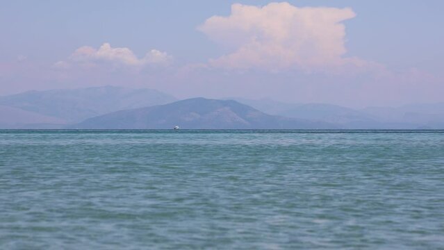 View from beach in Moraitika village over Ionian Sea, Corfu Island in Greece
