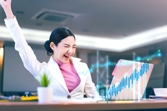 Happy office business asian woman show a financial stock market increase profit graph