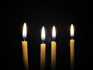 Burning candles isolated on black background.