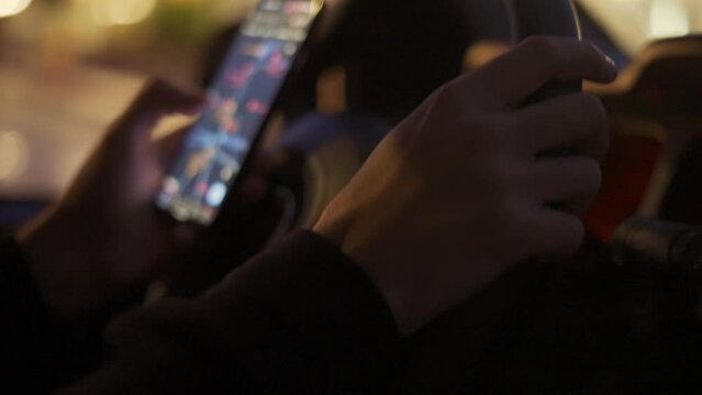 A man looking map on his mobile phone during driving at night