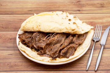 Doner kebab on a wooden background. Traditional Turkish cuisine flavor meat doner.