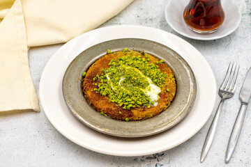 Pistachio kunefe on stone background. Traditional Turkish cuisine flavor