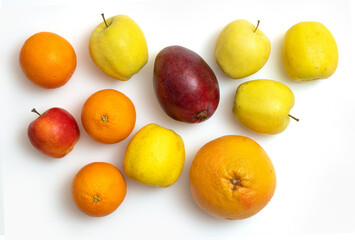 Top view of fresh different apples, citrus fruits and mango isolated on white background.