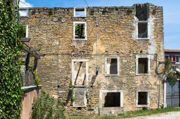 Fototapeta na wymiar Old abandoned and ruined stone house in a small village Oprtalj Portole in central Istria, Croatia