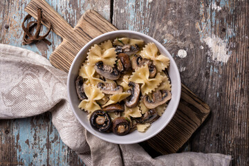 Bowl of italian farfalle pasta and mushrooms with cream sauce