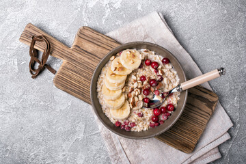 Healthy breakfast with oatmeal, berry, nuts and banana