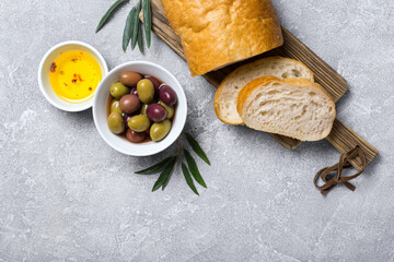 Bowl of delicious olives with oil and bread