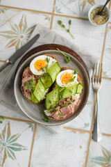 Sandwiches with wheat bread, cream cheese, canned tuna, fresh cucumber, boiled eggs and pea microgreens. A light, nutritious snack for a healthy lunch