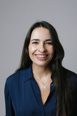Fototapeta premium Active beautiful middle-aged woman smiling friendly and looking in camera. 