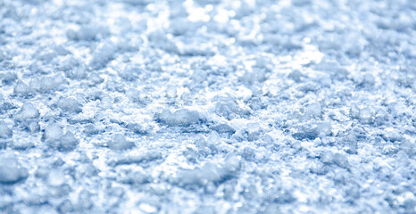 Fototapeta na wymiar Ice surface Closeup, Abstract background. Nature ice background white white bokeh with frozen ice bumps lying on the icy surface, beautiful cold blue winter landscape
