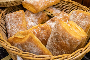Close up photo of bread (Ciabatta) piled in a basket