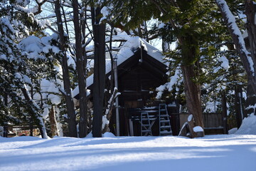 The Tsukisamu shrine temple fully covered by the white snow in Sapporo Japan