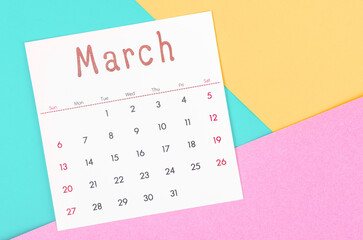 March 2022 calendar on multicolored background.
