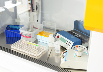 workplace of a medical worker in a PCR laboratory - dispensers, containers with test tubes