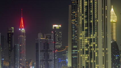 Fototapeta na wymiar Row of the tall buildings around Sheikh Zayed Road and DIFC district aerial all night timelapse in Dubai