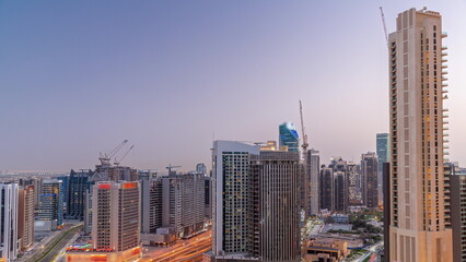 Fototapeta na wymiar Skyscrapers at the Business Bay in Dubai aerial day to night timelapse, United Arab Emirates