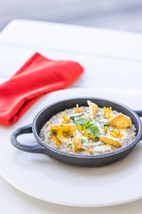 Beautiful and tasty food on a plate. Gourmet dish on white table with red napkin, luxury hotel resort special meal. Truffle mushroom and vegetables. Luxury vegan lifestyle elegant table setting
