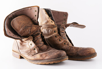 Old shoes on a white background. Leather brown shoe. Worn shoes. Boots.